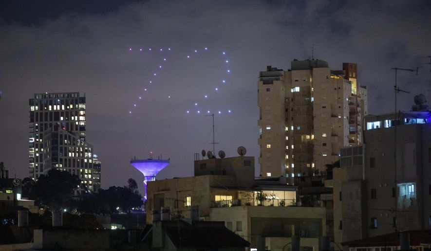 Drones form number 72 during celebrations for Israel's 72nd Independence Day, in Ramat Gan, Israel, Tuesday, April 28, 2020. Israel government announced a complete lockdown over the upcoming Israel's 72nd Independence Day to control the country's coronavirus outbreak. (AP Photo/Oded Balilty)