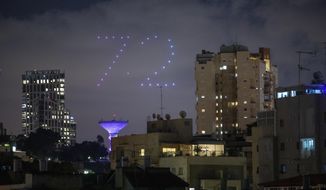 Drones form number 72 during celebrations for Israel&#39;s 72nd Independence Day, in Ramat Gan, Israel, Tuesday, April 28, 2020. Israel government announced a complete lockdown over the upcoming Israel&#39;s 72nd Independence Day to control the country&#39;s coronavirus outbreak. (AP Photo/Oded Balilty)