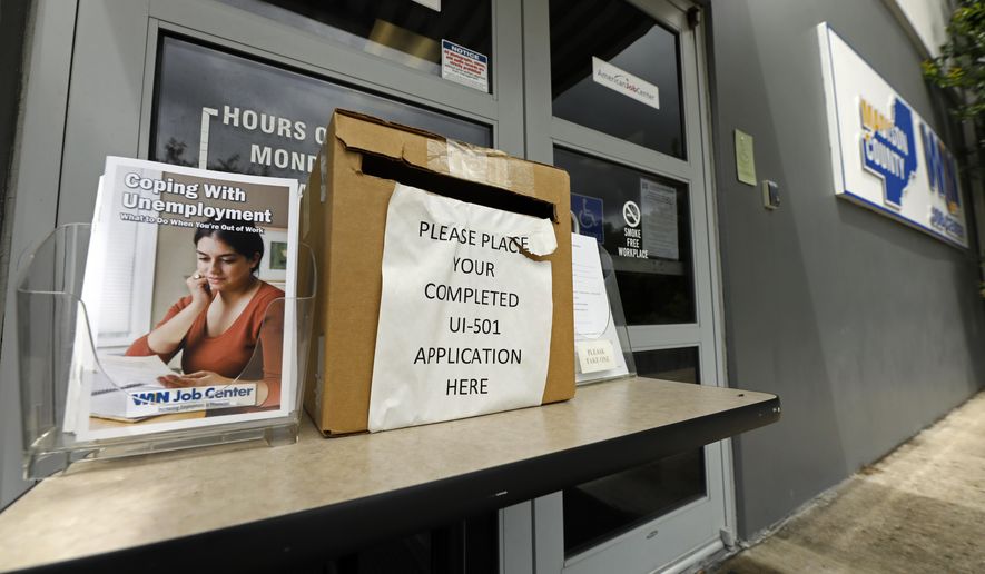 A booklet for coping with unemployment rests next to a application deposit box at a state WIN job center in Canton, Miss., Wednesday, April 29, 2020. The job centers lobbies are closed statewide to prevent the spread of COVID-19 coronavirus. However the continuing growth of unemployment demands and the various problems with obtaining online unemployment assistance, both technical and personal has drawn some people to the centers for information and to obtain and submit unemployment benefit applications. (AP Photo/Rogelio V. Solis)