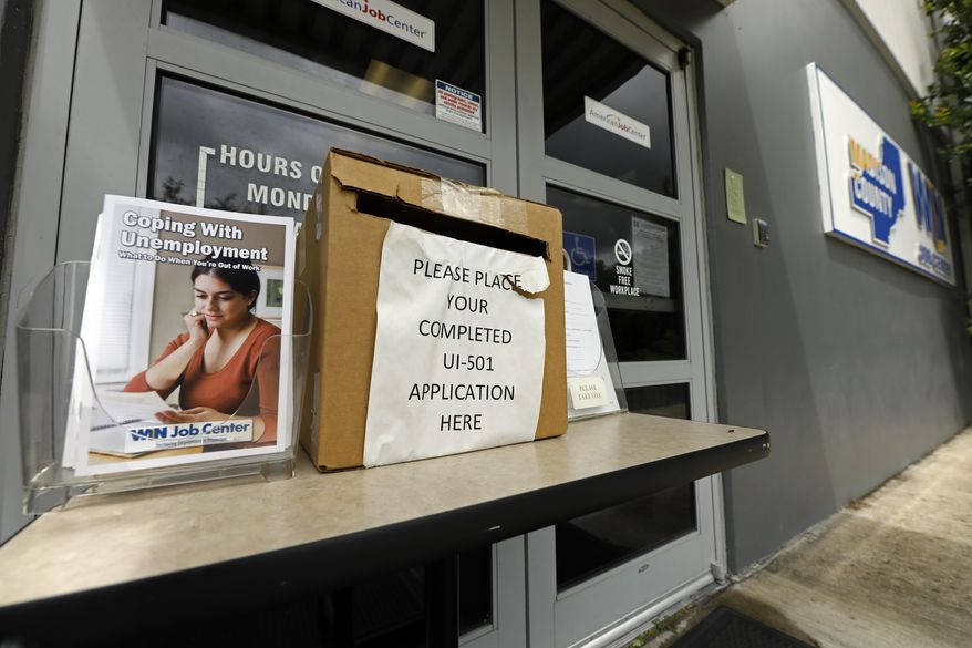 A booklet for coping with unemployment rests next to a application deposit box at a state WIN job center in Canton, Miss., Wednesday, April 29, 2020. The job centers lobbies are closed statewide to prevent the spread of COVID-19 coronavirus. However the continuing growth of unemployment demands and the various problems with obtaining online unemployment assistance, both technical and personal has drawn some people to the centers for information and to obtain and submit unemployment benefit applications. (AP Photo/Rogelio V. Solis)