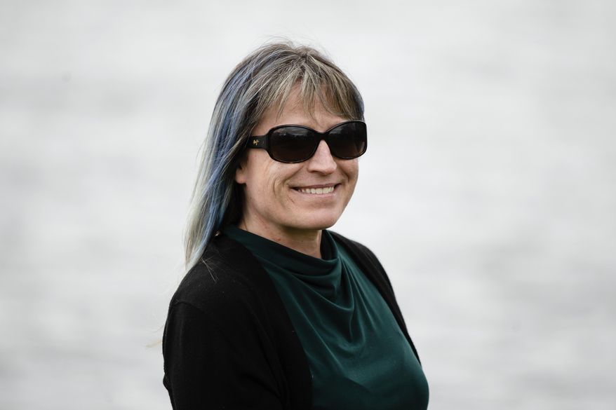 Michele Cody poses for a photograph in Riverton, N.J., Wednesday, April 29, 2020. Cody says she's become so worn down by the crush of information that she’s put herself on a news diet, giving up her early morning newscast and relying more on a roundup of coronavirus news pushed to her inbox. Americans are grappling with an essential question as they try to get the information they need to stay safe during the coronavirus crisis: Whom do you trust? (AP Photo/Matt Rourke)