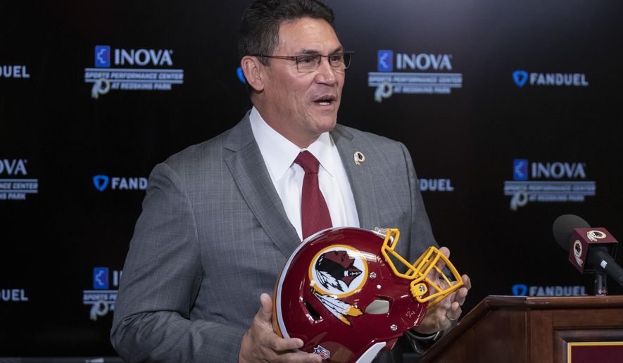 In this Jan. 2, 2020, file photo, Washington Redskins new head coach Ron Rivera holds up a helmet during a news conference at the team&#x27;s NFL football training facility in Ashburn, Va. The NFL Draft is April 23-25. (AP Photo/Alex Brandon) ** FILE **