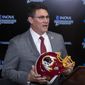 In this Jan. 2, 2020, file photo, Washington Redskins new head coach Ron Rivera holds up a helmet during a news conference at the team&#39;s NFL football training facility in Ashburn, Va. The NFL Draft is April 23-25. (AP Photo/Alex Brandon) ** FILE **