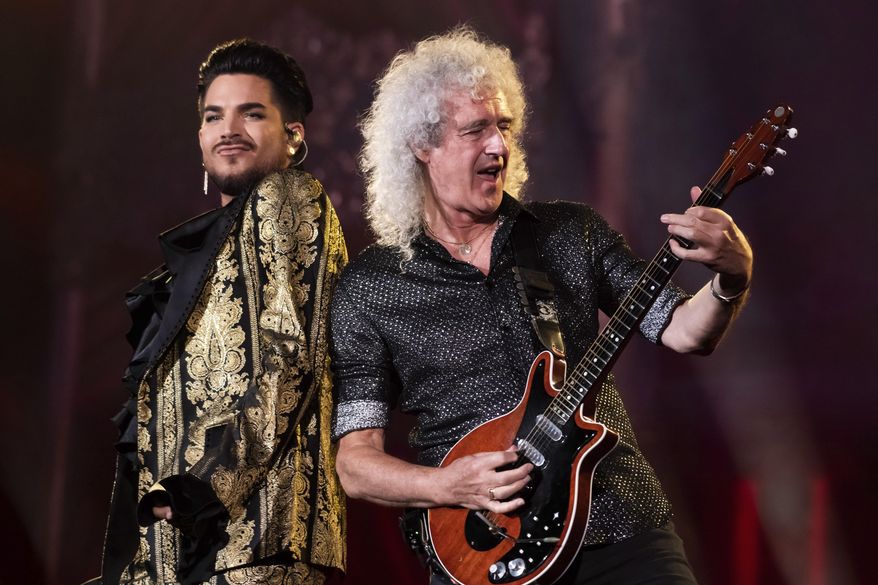 FILE - In this Sept. 28, 2019 file photo, Adam Lambert, left, and Brian May, of Queen, perform at the Global Citizen Festival in New York. Lambert and May, along with bandmate Roger Taylor, recently gathered virtually to record a new version of the Queen classic, “We Are the Champions.” “You Are the Champions” was released early Friday on all streaming and download services, with proceeds going to the World Health Organization’s COVID-19 Solidarity Response Fund.  (Photo by Charles Sykes/Invision/AP, File)