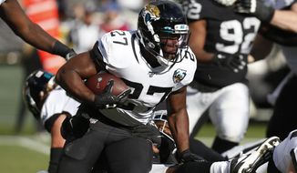 FILE - In this Sunday, Dec. 15, 2019 file photo,Jacksonville Jaguars running back Leonard Fournette runs with the ball during the second half of an NFL football game against the Oakland Raiders in Oakland, Calif. The Jacksonville Jaguars are ready to move on from running back Leonard Fournette, Monday, April 20, 2020. A person familiar with the decision says the Jaguars are actively looking to trade the fourth overall pick in the 2017 NFL draft. The person spoke to The Associated Press on condition of anonymity because the team hasn’t made its plans public.(AP Photo/D. Ross Cameron, File)