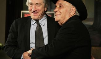 FILE - In this Jan. 27, 2005, file photo, Robert De Niro, left, and boxer Jake LaMotta stand for photographers before watching a 25th anniversary screening of the movie &amp;quot;Raging Bull,&amp;quot; in New York. &amp;quot;Raging Bull,&amp;quot; about the life of Jake Lamotta, was No. 7 in The Associated Press’ Top 25 favorite sports movies poll. (AP Photo/Julie Jacobson, File)