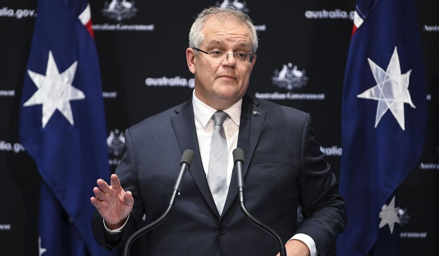 Australian Prime Minister Scott Morrison speaks to the media during a press conference at Parliament House in Canberra, Friday, May 1, 2020. Morrison stands firm on his call for an independent inquiry into the coronavirus and denied any motivation other than to prevent such a pandemic happening again. (Lukas Coch/AAP Image via AP)