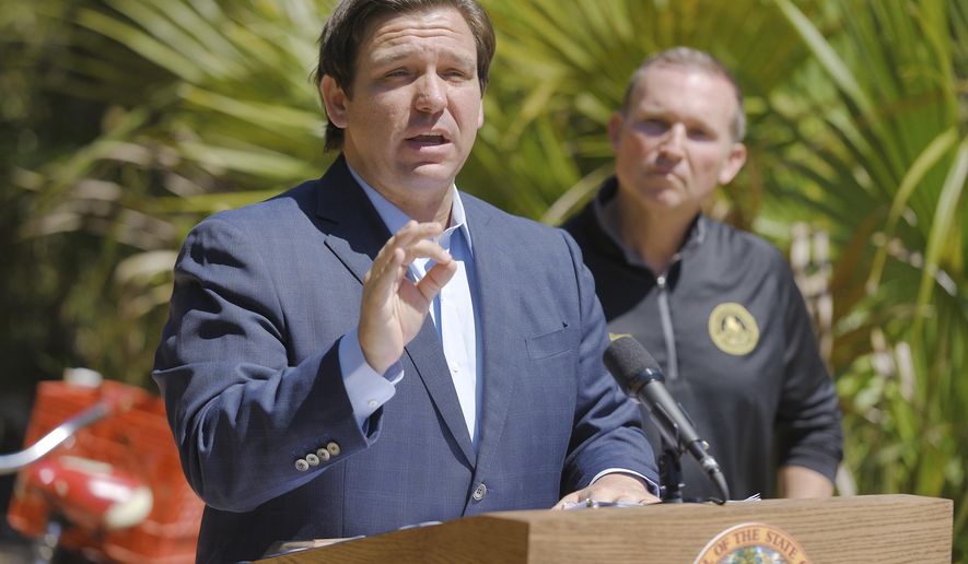 Florida Gov. Ron DeSantis speaks during a news conference alongside Jacksonville Mayor Lenny Curry  at Little Talbot Island State Park Friday, May 1, 2020. During the exchange with members of the media the Governor announced that next week there would be a reopening of Florida&#39;s State Parks after their closing due to the COVID-19 outbreak. (Bob Self/The Florida Times-Union via AP)