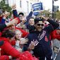 FILE - In this Nov. 2, 2019, file photo, Washington Nationals manager Dave Martinez celebrates with fans during a parade to celebrate the team&#x27;s World Series baseball championship over the Houston Astros in Washington. Martinez says the World Series champs will raise their banner and present their rings at their stadium with fans in attendance -- no matter how or when or if the 2020 season starts. Like his general manager, Mike Rizzo, Martinez is optimistic there will be a major league season this year and has been mapping out what a second spring training camp might look like. (AP Photo/Patrick Semansky, File)