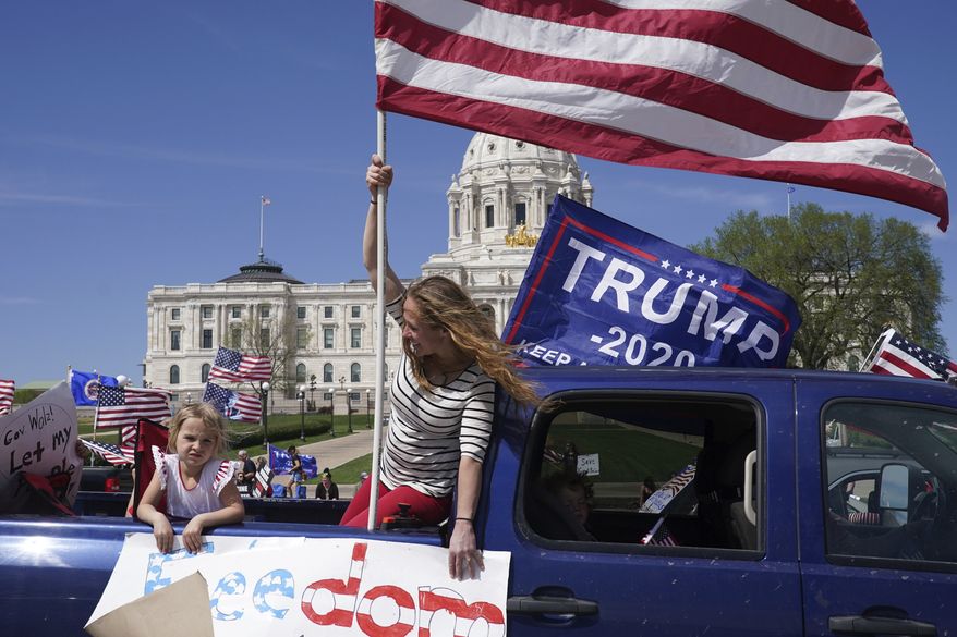 Supporters of President Donald Trump circle the State Capitol as they protest Gov. Tim Walz&#39;s &quot;Stay Home MN&quot; orders meant to slow the spread of COVID-19, Saturday, May 2, 2020, in St. Paul, Minn. (Anthony Souffle/Star Tribune via AP) ** FILE **