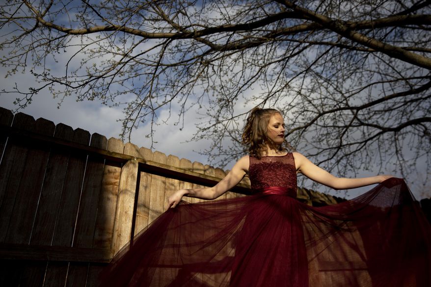 Washington High School senior Addison Thie wears her prom dress on Monday, April 20, 2020 at her home in Sioux Falls, S.D. (Abigail Dollins/The Argus Leader via AP)