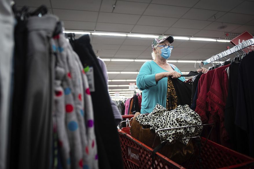Libby Boggs browses clothes for a wedding at Martin's Family Clothing as state restrictions loosen amid the coronavirus outbreak, allowing retail stores to reopen, Thursday, April 30, 2020, in Decatur, Ala. (Dan Busey/The Decatur Daily via AP)