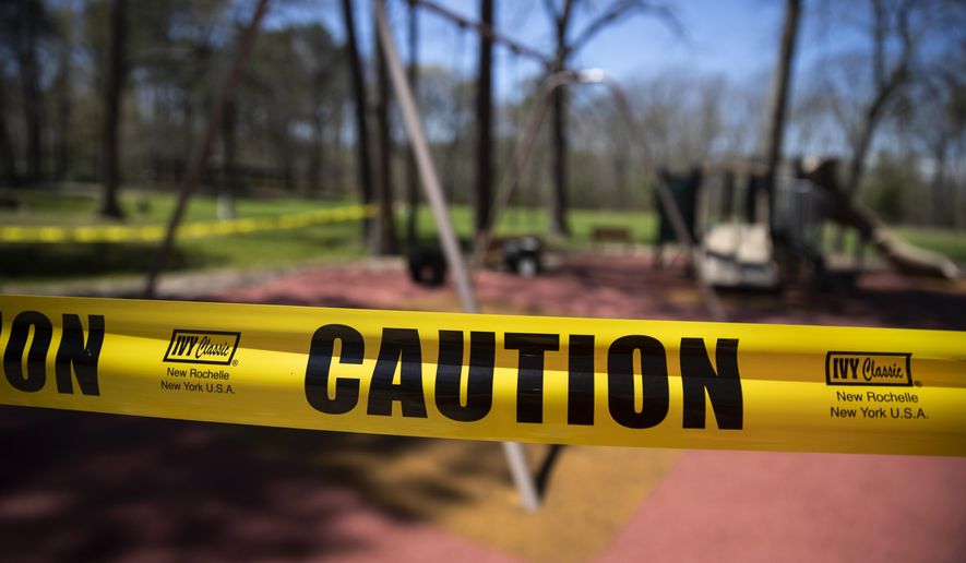 A playground is cordoned off at Shark River Park in Wall Township, N.J., Saturday, May 2, 2020. Parks and golf courses reopened Saturday after being closed to to the coronavirus pandemic. (AP Photo/Matt Rourke)