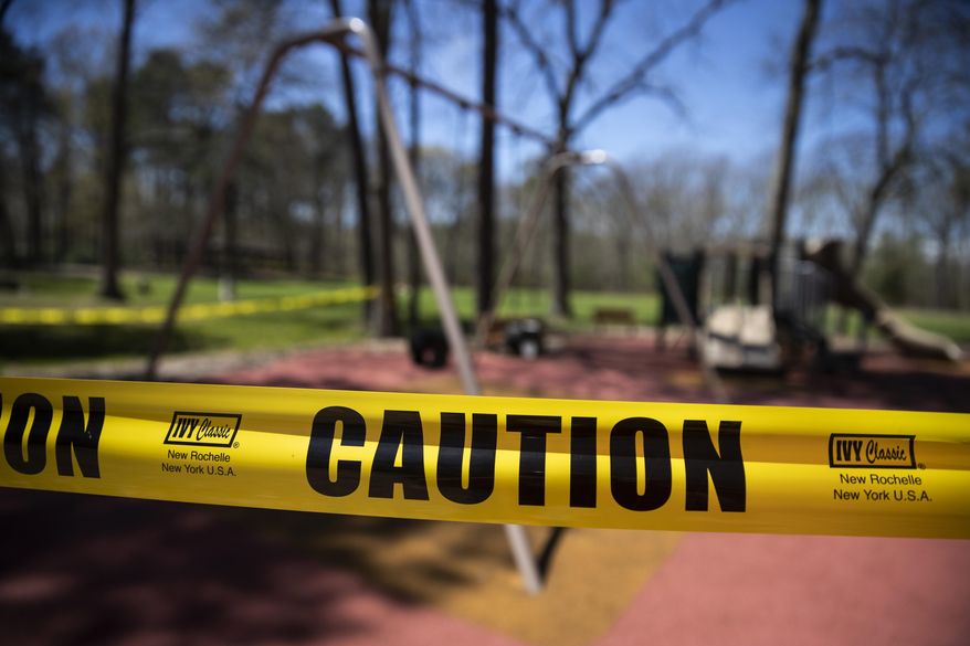 A playground is cordoned off at Shark River Park in Wall Township, N.J., Saturday, May 2, 2020. Parks and golf courses reopened Saturday after being closed to to the coronavirus pandemic. (AP Photo/Matt Rourke)