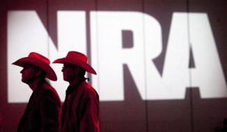 In this May 4, 2013, file photo, National Rifle Association members listen to speakers during the NRA&#39;s annual Meetings and Exhibits at the George R. Brown Convention Center in Houston. (Johnny Hanson/Houston Chronicle via AP, File)