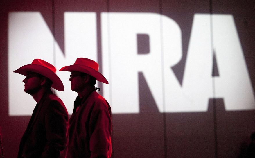 In this May 4, 2013, file photo, National Rifle Association members listen to speakers during the NRA&#39;s annual Meetings and Exhibits at the George R. Brown Convention Center in Houston. (Johnny Hanson/Houston Chronicle via AP, File)