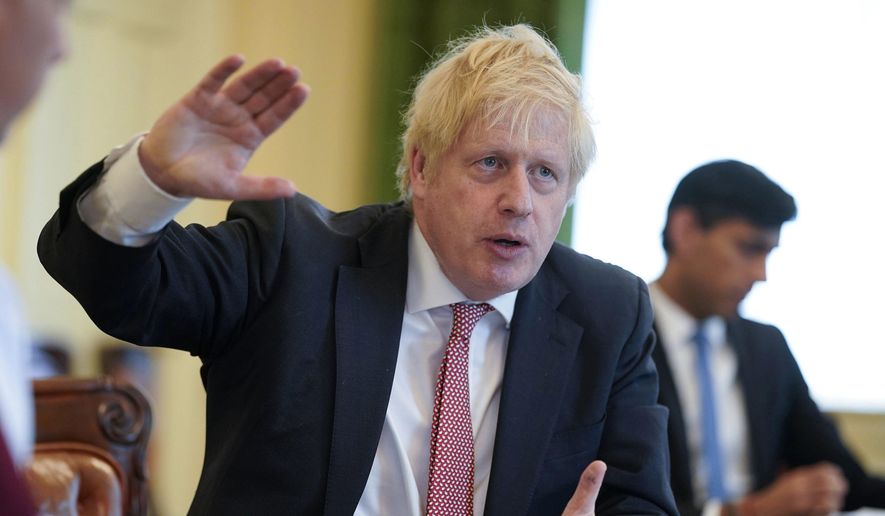 In this photo provided by10 Downing Street, Britain's Prime Minister Boris Johnson chairs his first digital Cabinet meeting inside the Cabinet Room of No 10, since he returned to work after contracting coronavirus and the birth of his new son with his partner Carrie Symonds, in London, Thursday April 30, 2020. (Andrew Parsons/10 Downing Street/via AP)