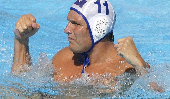FILE - In this July 28, 2009, file photo, Jesse Smith, of the United States, reacts during a waterpolo quarterfinal match against Germany at the FINA Swimming World Championships in Rome. One way Smith is dealing with the coronavirus pandemic is through virtual speaking engagements with water polo clubs and teams all over the country, passing along what he has learned during a couple decades in the water. (AP Photo/Alessandra Tarantino, File)