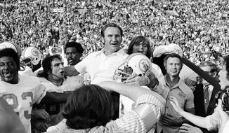 FILE - In this Jan. 14, 1973, file photo, Miami Dolphins coach Don Shula is carried off the field after his team won  the NFL football Super Bowl game 14-7 against the Washington Redskins in Los Angeles. Shula, who won the most games of any NFL coach and led the Miami Dolphins to the only perfect season in league history, died Monday, May 4, 2020, at his home in Indian Creek, Fla., the team said. He was 90.  (AP Photo/File)