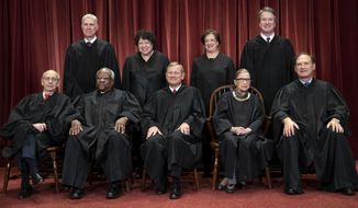 In this Nov. 30, 2018, file photo, the justices of the U.S. Supreme Court gather for a formal group portrait to include the new Associate Justice, top row, far right, at the Supreme Court building in Washington. Seated from left: Associate Justice Stephen Breyer, Associate Justice Clarence Thomas, Chief Justice of the United States John G. Roberts, Associate Justice Ruth Bader Ginsburg and Associate Justice Samuel Alito Jr. Standing behind from left: Associate Justice Neil Gorsuch, Associate Justice Sonia Sotomayor, Associate Justice Elena Kagan and Associate Justice Brett M. Kavanaugh. (AP Photo/J. Scott Applewhite, File)