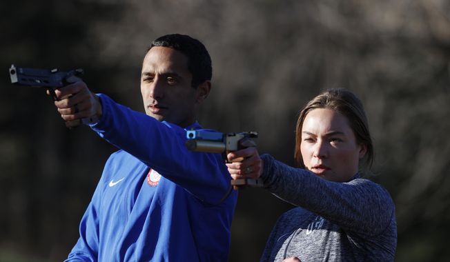USA Olympic modern pentathlon team members Amro ElGeziry and his wife, Isabella Isaksen practice shooting at targets in a park in Colorado Springs, Colo., Friday, April 24, 2020. Amro Elgeziry and Isabella Isaksen are just your ordinary married Olympic modern pentathlon couple trying to navigate their way through the challenges of training during the coronavirus pandemic. Their sport consists of five events, but they can&#x27;t practice equestrian horse jumping or swimming at the moment with the facilities closed. For the rest, they improvise. They practice their fencing footwork in the backyard, shoot laser pistols at a target in a nearby park and squeeze in early morning runs along trails as they train for the Tokyo Games in 2021. (AP Photo/David Zalubowski) **FILE**