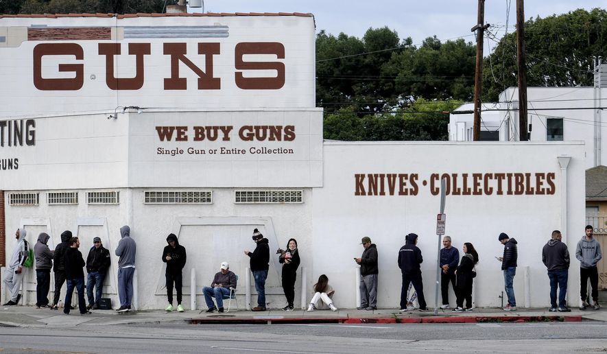 In this March 15, 2020, file photo, people wait in line to enter a gun store in Culver City, Calif.  (AP Photo/Ringo H.W. Chiu, File)  **FILE**