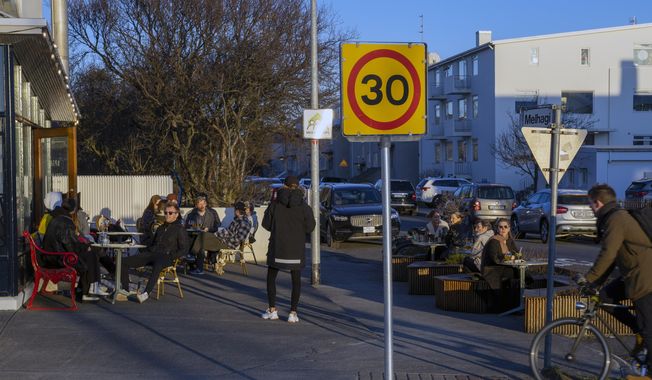 In this photo taken on Wednesday, April 29, 2020, people gather at a restaurant in Reykjavik after the country recorded days of zero new cases of COVID-19. High schools, dentists and hair salons are about to reopen in Iceland, which has managed to get a grip on the coronavirus through the world’s most extensive regime of testing. By identifying infected people even when they had no symptoms, the tiny North Atlantic nation managed to identify and isolate cases where many bigger countries have struggled. (AP Photo/Egill Bjarnason)