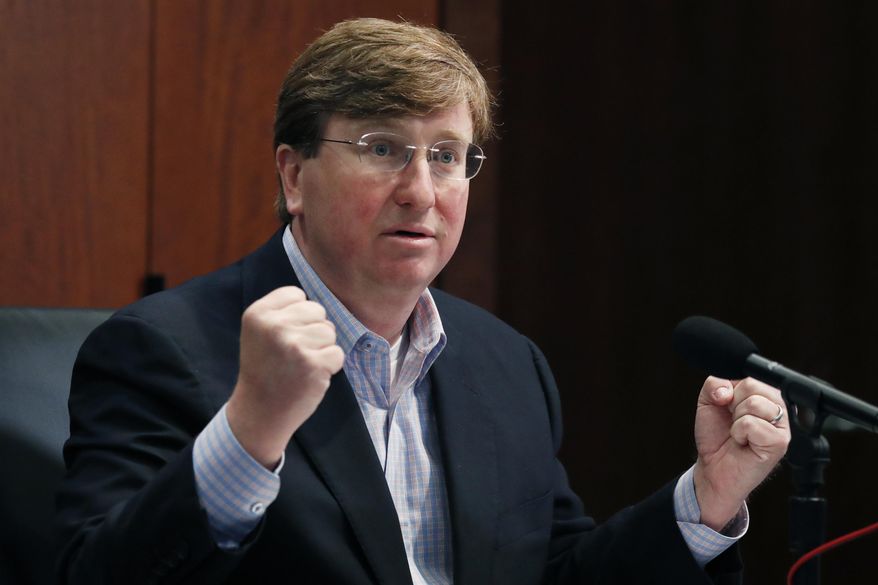 Republican Gov. Tate Reeves gestures Monday, May 4, 2020, in Jackson, Miss., as he wonders how needy state residents are being helped when lawmakers passed a bill May 1, that takes control of the federal CARES Act money, during his daily update on the state's response to COVID-19. (AP Photo/Rogelio V. Solis)