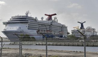Carnival Cruise ships are docked at the Port of Tampa Thursday, March 26, 2020, in Tampa, Fla. Thousands of cruise ships employees are not working in an attempt to stop the spread of the coronavirus. (AP Photo/Chris O&#x27;Meara)