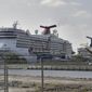 Carnival Cruise ships are docked at the Port of Tampa Thursday, March 26, 2020, in Tampa, Fla. Thousands of cruise ships employees are not working in an attempt to stop the spread of the coronavirus. (AP Photo/Chris O&#39;Meara)
