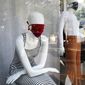 Mannequins wear masks, a reference to the new coronavirus, inside a newly opened clothing store in Asuncion, Paraguay, Monday, May 4, 2020. The government authorized the opening of some stores under the plan coined &amp;quot;Intelligent quarantine.&amp;quot; (AP Photo/Jorge Saenz)