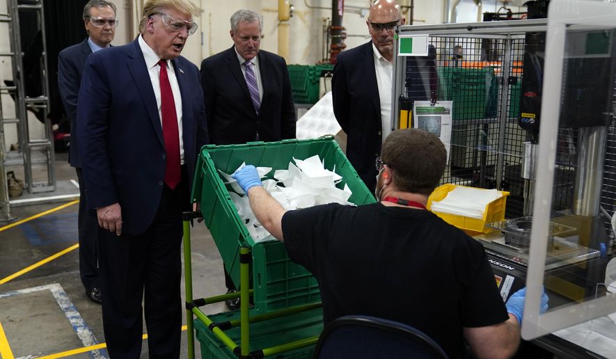 President Donald Trump participates in a tour of a Honeywell International plant that manufactures personal protective equipment, Tuesday, May 5, 2020, in Phoenix, with Tony Stallings, vice president of Integrated Supply Chain at Honeywell, right and White House chief of staff Mark Meadows. (AP Photo/Evan Vucci)