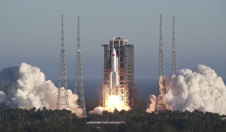 In this photo released by Xinhua News Agency, China's new large carrier rocket Long March-5B blasts off from the Wenchang Space Launch Center in southern China's Hainan Province, May 5, 2020. The Long March-5B made its maiden flight on Tuesday, sending the trial version of China's new-generation manned spaceship and a cargo return capsule for test into space. (Tu Haichao/Xinhua via AP)