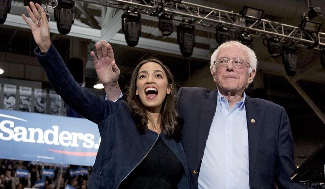 In this Feb. 10, 2020, file photo, Democratic presidential candidate Sen. Bernie Sanders, I-Vt., right, and Rep. Alexandria Ocasio-Cortez, D-N.Y. wave to supporters at a campaign stop at Whittemore Center Arena at the University of New Hampshire in Durham, N.H. On Tuesday, May 5, federal Judge Analisa Torres ruled that the New York Democratic presidential primary must take place June 23 because canceling it would be unconstitutional. (AP Photo/File, Andrew Harnik)