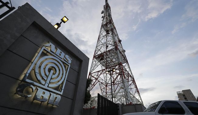 A vehicle enters the property of the broadcast network ABS-CBN on Tuesday, May 5, 2020, in Manila, Philippines. A government agency has ordered ABS-CBN, the country's leading broadcast network, which the president has targeted for its critical news coverage, to halt operations. (AP Photo/Aaron Favila)