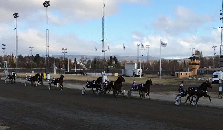 In this photo taken on Thursday, April 30, 2020, horse race at the Bergsaker racecourse in Vasternorrland, Sweden. Swedish trotting is one of only a handful of European sports to have persevered during the coronavirus outbreak while competitions elsewhere shut down across the continent. That’s not just good news for the 40,000 people working in the equestrian sector in Sweden. It’s something of a savior for betting companies and gamblers around the world who have been starved of their usual diet of top-class sport in Europe. (AP Photo/Steve Douglas)