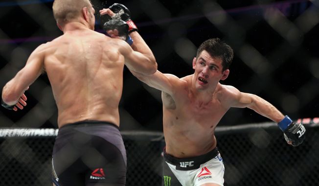 FILE - In this Jan. 17, 2016, file photo, Dominick Cruz throws a right against TJ Dillashaw in their mixed martial arts title bout at UFC Fight Night 81 n Boston. Cruz is scheduled to fight against Henry Cejudo at UFC249 in Jacksonville, Fla., on Saturday, May 9, 2020. (AP Photo/Gregory Payan, File)
