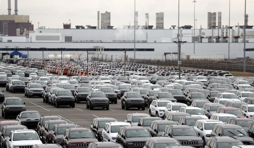 FILE - In this Feb. 26, 2019 file photo, Jeep vehicles are parked outside the Jefferson North Assembly Plant in Detroit. Major U.S. automakers are planning to reopen North American factories within two weeks, potentially putting thousands of workers back on the assembly line, as part of a gradual return to normality. Fiat Chrysler CEO Mike Manley said Tuesday, May 5, 2020, his company plans to start reopening factories May 18 depending on easing of government restrictions. (AP Photo/Carlos Osorio, File)
