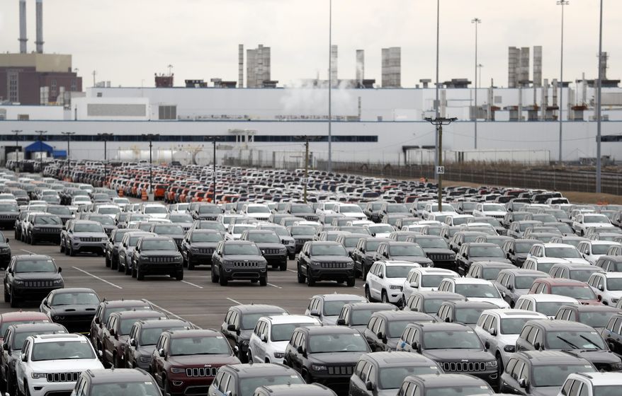 FILE - In this Feb. 26, 2019 file photo, Jeep vehicles are parked outside the Jefferson North Assembly Plant in Detroit. Major U.S. automakers are planning to reopen North American factories within two weeks, potentially putting thousands of workers back on the assembly line, as part of a gradual return to normality. Fiat Chrysler CEO Mike Manley said Tuesday, May 5, 2020, his company plans to start reopening factories May 18 depending on easing of government restrictions. (AP Photo/Carlos Osorio, File)