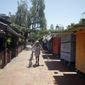 Christine Olivarri walks along the shuttered shops on Olvera Street amid the COVID-19 pandemic Tuesday, May 5, 2020, in Los Angeles. (AP Photo/Marcio Jose Sanchez)