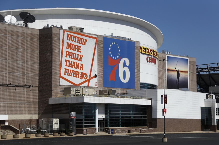 FILE - This is a March 14, 2020, file photo showing the Wells Fargo Center, home of the Philadelphia Flyers NHL hockey team and the Philadelphia 76ers NBA basketball team. The Philadelphia Flyers and 76ers are set to offer refunds or credits for unplayed regular-season games at their shared arena because of the coronavirus pandemic. While neither the NHL or NBA has officially canceled the remainder of the season, or decided when and where the season may resume, both organizations on Tuesday, May 5, 2020, decided to address the ticket status for games scheduled for the Wells Fargo Center. (AP Photo/Matt Slocum, File)