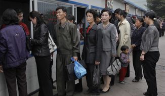 FILE- In this Oct. 11, 2010, file photo, residents queue up at a store to buy food in Pyongyang, North Korea. The coronavirus pandemic appears to be taking a heavy toll on North Korea, forcing its leader Kim Jong Un to sharply shrink his public activities and his people to go on panic buying of daily necessities, South Korea&#39;s spy agency told lawmaker Wednesday, May 6, 2020. (AP Photo/Vincent Yu, File)