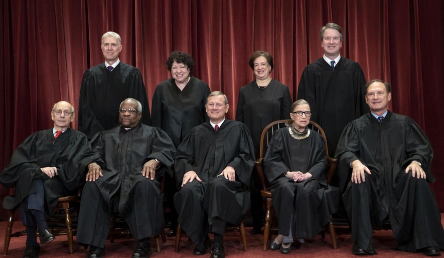 FILE - In this Nov. 30, 2018, file photo, the justices of the U.S. Supreme Court gather for a formal group portrait to include a new Associate Justice, top row, far right, at the Supreme Court Building in Washington. Seated from left: Associate Justice Stephen Breyer, Associate Justice Clarence Thomas, Chief Justice of the United States John G. Roberts, Associate Justice Ruth Bader Ginsburg and Associate Justice Samuel Alito Jr. Standing behind from left: Associate Justice Neil Gorsuch, Associate Justice Sonia Sotomayor, Associate Justice Elena Kagan and Associate Justice Brett M. Kavanaugh. (AP Photo/J. Scott Applewhite, File)