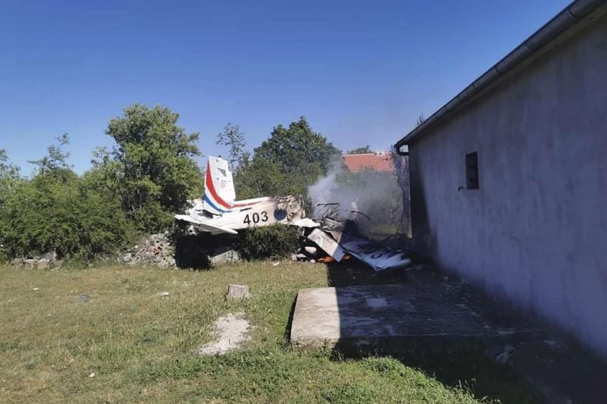 A Croatian air force plane burns after crashing in Biljane, Croatia, Thursday, May 7, 2020. Croatia’s Defense Ministry says an air force training plane crashed and two crew members were killed during a routine training flight Thursday afternoon. (Diadora TV via AP)