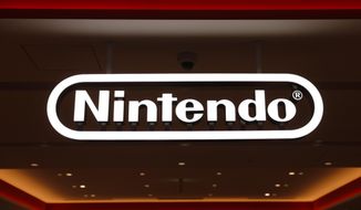 In this Jan. 23, 2020, photo, a Nintendo sign is seen at the company&#39;s official store in the Shibuya district of Tokyo, Thursday, Jan. 23, 2020. Japanese video-game maker Nintendo Co. has scored a 33% jump in annual profit as people stuck at home during the coronavirus pandemic turn to playing games. (AP Photo/Jae C. Hong)