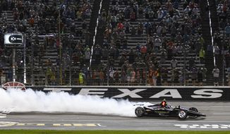 FILE - In this June 8, 2019, file photo, Josef Newgarden celebrates winning the IndyCar auto race at Texas Motor Speedway in Fort Worth, Texas. IndyCar has gotten the green flag to finally start its season in Texas. The race will be run June 6 without spectators at Texas Motor Speedway. (AP Photo/Randy Holt, File)