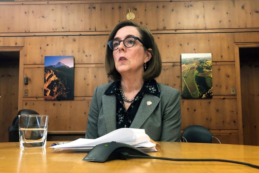 In this July 1, 2019, file photo, Oregon Gov. Kate Brown speaks with the media at the Capitol in Salem, Ore. (AP Photo/Sarah Zimmerman, File)