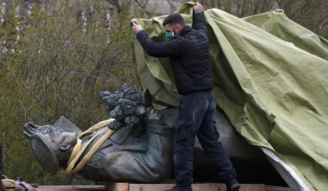 FILE - In this file photo taken on Friday, April 3, 2020, a worker covers the statue of a Soviet World War II commander Marshall Ivan Stepanovic Konev for removal from its site in Prague, Czech Republic. Relations between the Czech Republic and Russia have taken a turn for the worse in a series of disputes over the interpretation of historical events. Three Prague politicians whose recent actions upset Russia have been placed under police protection amid a media report that Russian intelligence services have been plotting to poison them with the deadly toxin ricin. Russia has opened a criminal investigation into Prague&#x27;s removal of a war memorial to a World War II hero, among other actions that have tested diplomatic ties.  (AP Photo/Petr David Josek/File)