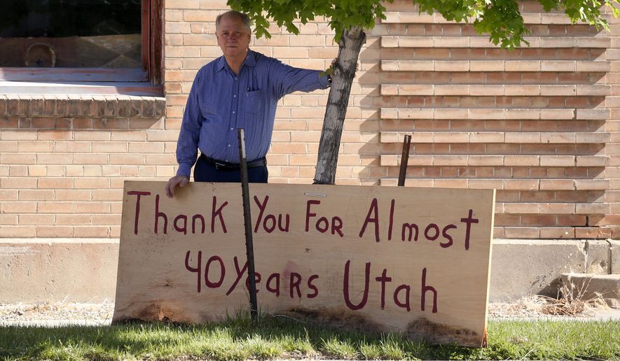Euro Treasures Antiques owner Scott Evans poses next to a "thank You" sign Friday, May 8, 2020, in Salt Lake City. Evans is closing his art and antique store after 40 years. With a drastic drop in customers due to COVID-19 concerns and shelter-in-place orders, Evans says it was no longer cost effective to stay open. (AP Photo/Rick Bowmer)
