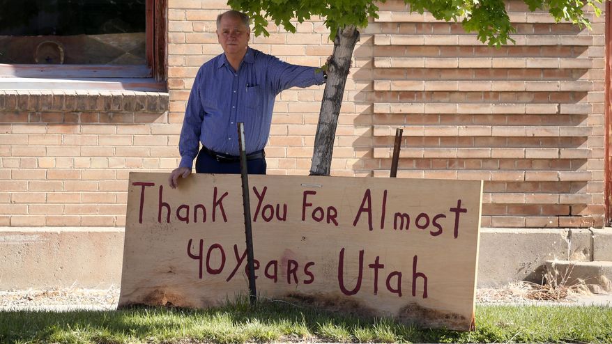Euro Treasures Antiques owner Scott Evans poses next to a "thank You" sign Friday, May 8, 2020, in Salt Lake City. Evans is closing his art and antique store after 40 years. With a drastic drop in customers due to COVID-19 concerns and shelter-in-place orders, Evans says it was no longer cost effective to stay open. (AP Photo/Rick Bowmer)